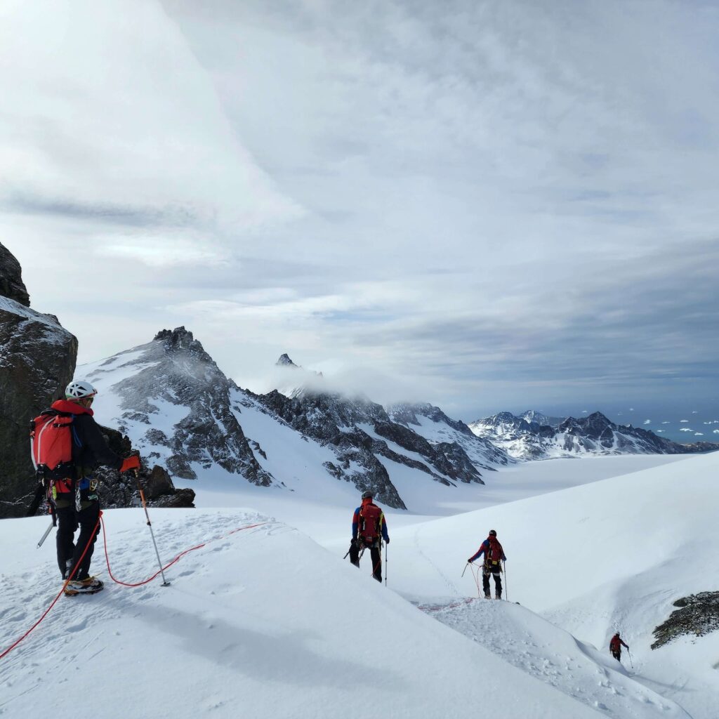 Salomon Glacier hiking in the snow wearing Paramo jackets